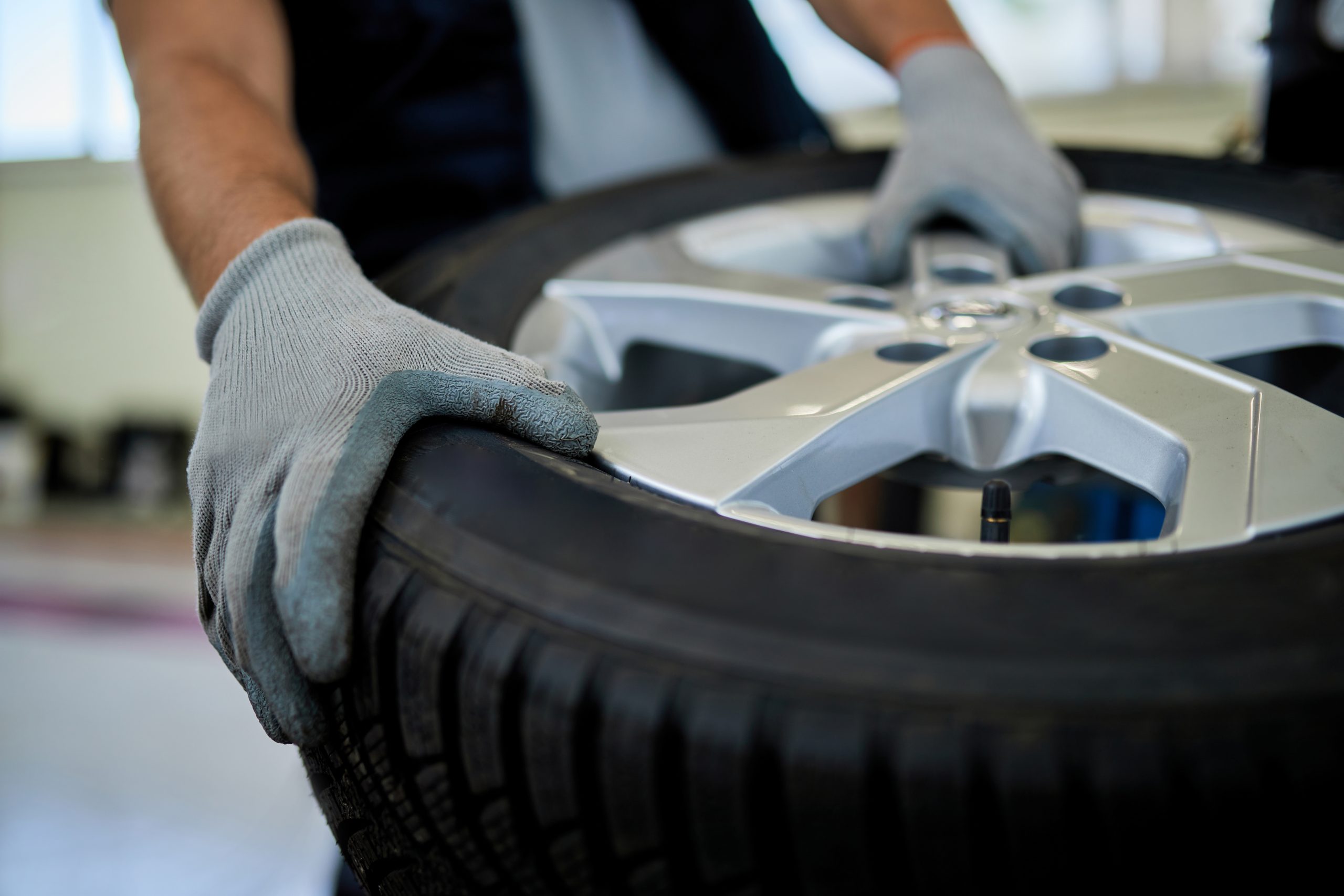 Retail tire services performed by a professional mechanic installing a tire at TruFix Auto Repair in Nampa ID