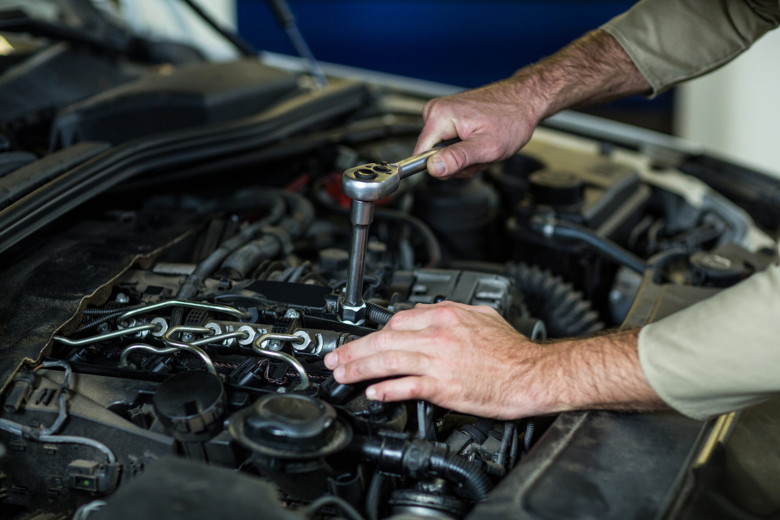 Mechanic inspecting a vehicle transmission during repair in Nampa, ID