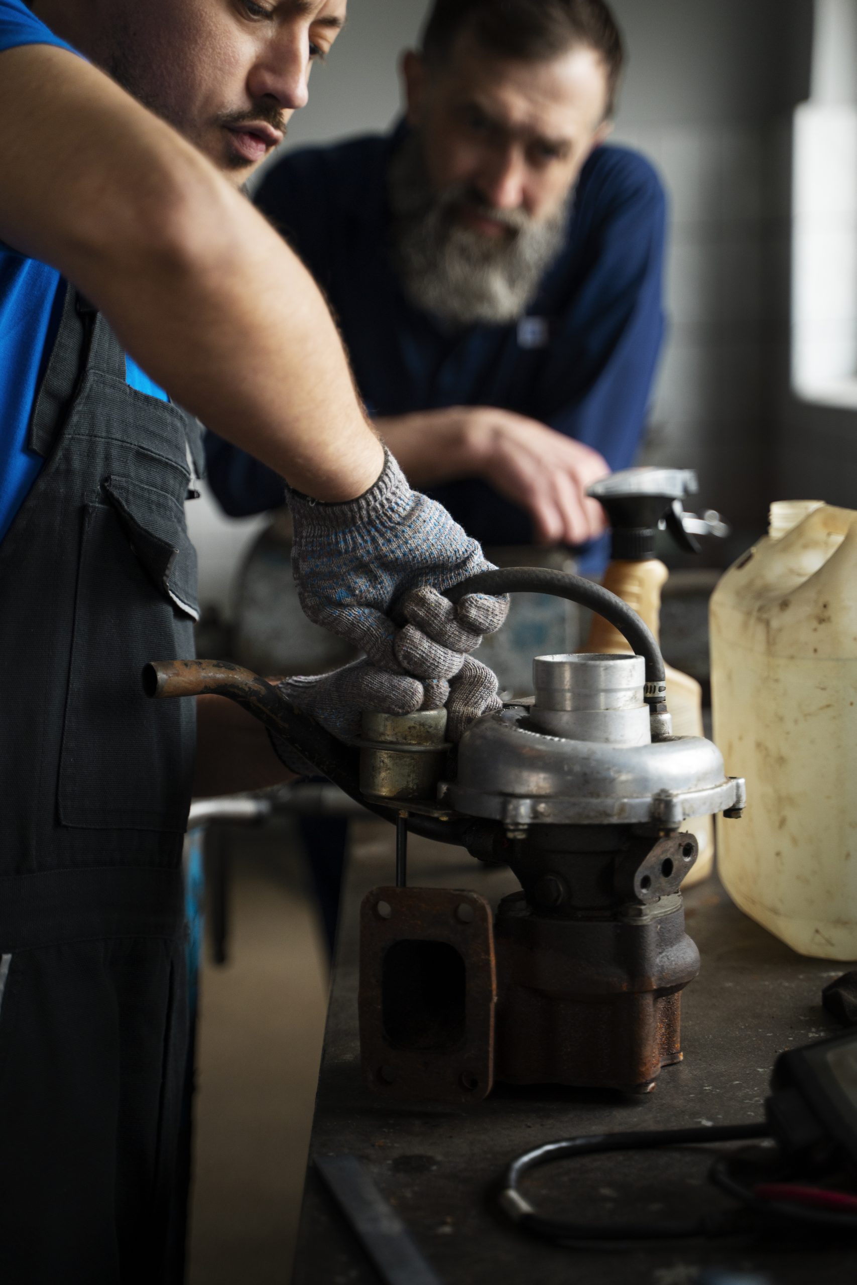 Mechanics working together to diagnose and repair a vehicle transmission
