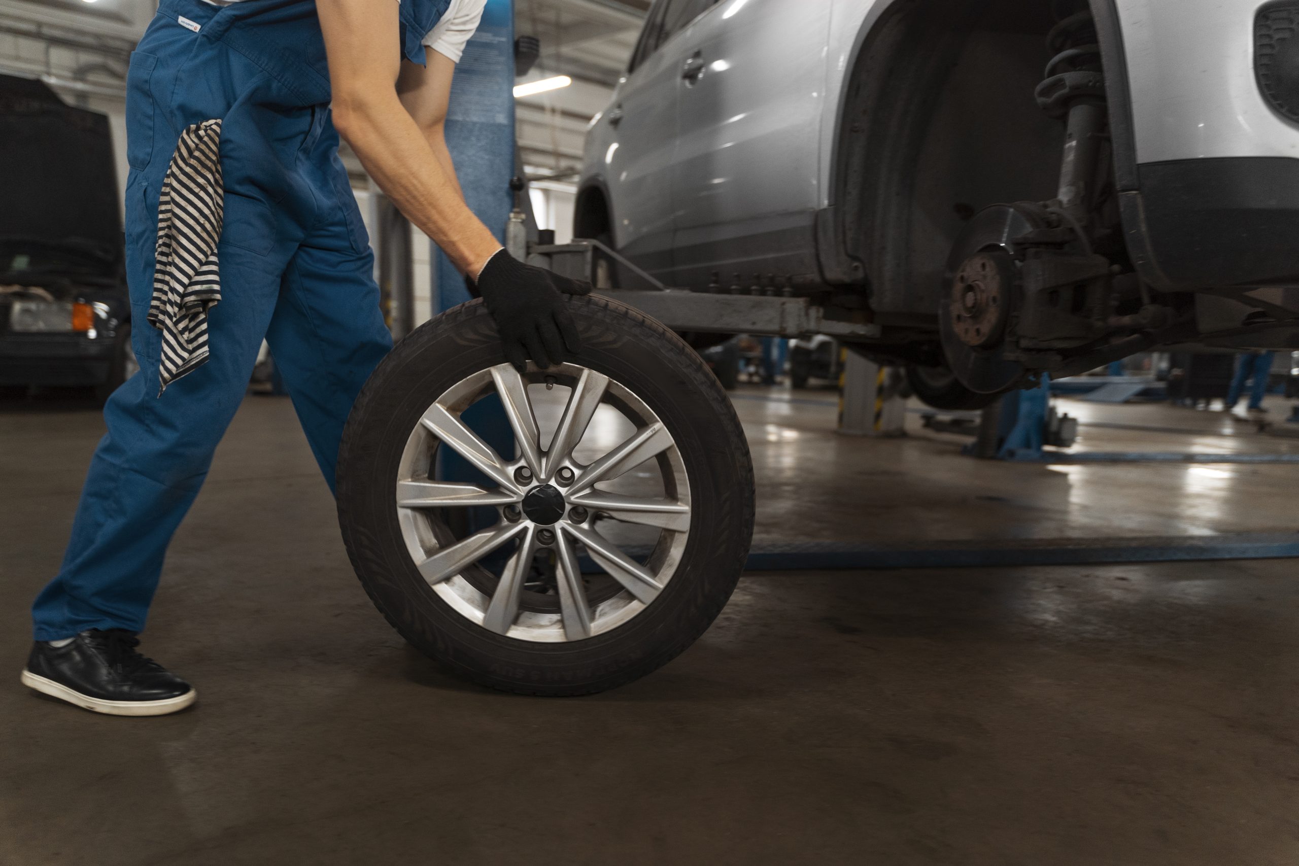 Retail tire services performed by a professional mechanic installing a wheel at TruFix Auto Repair in Nampa ID