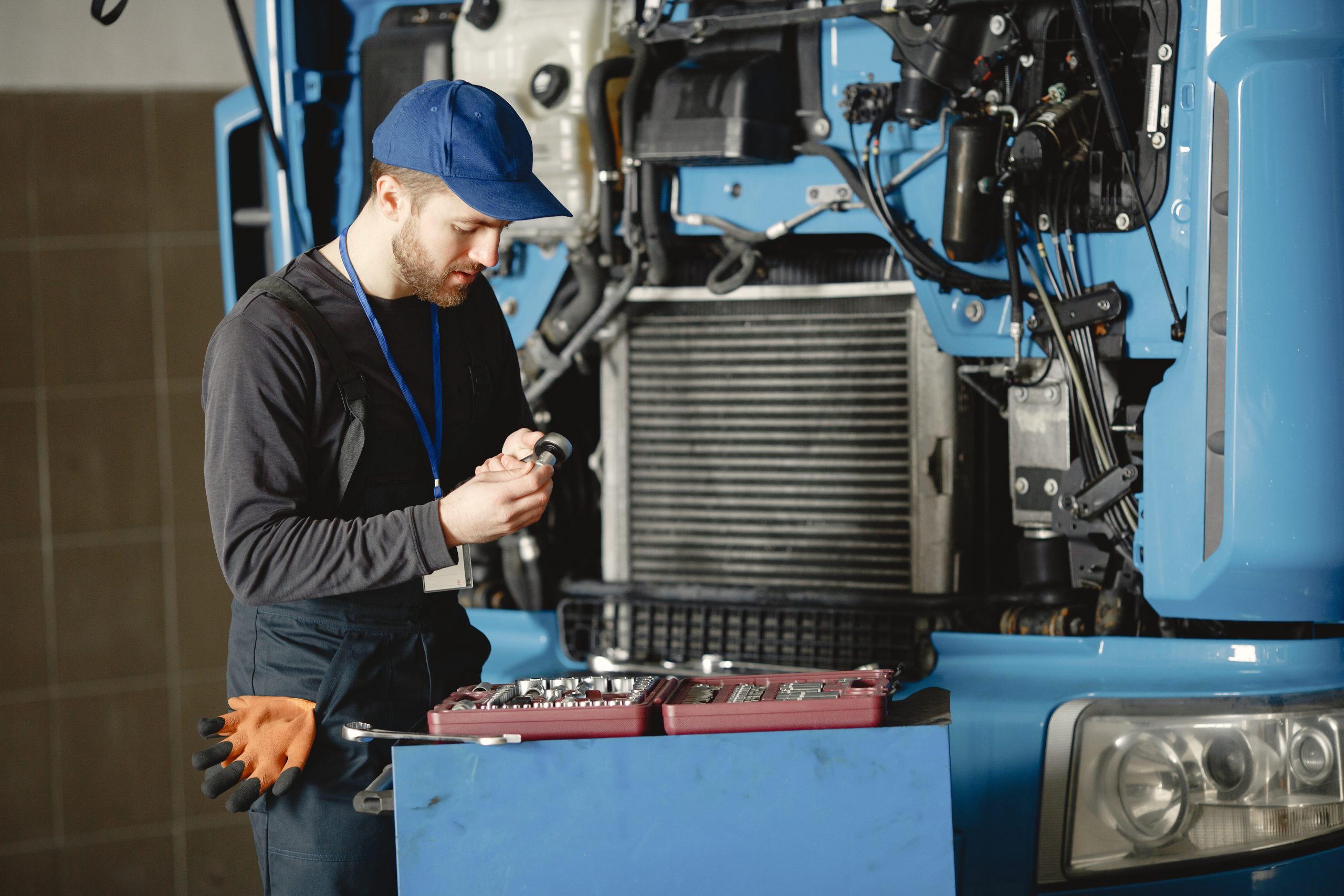 diesel mechanic showing another technician how to diagnose a truck engine