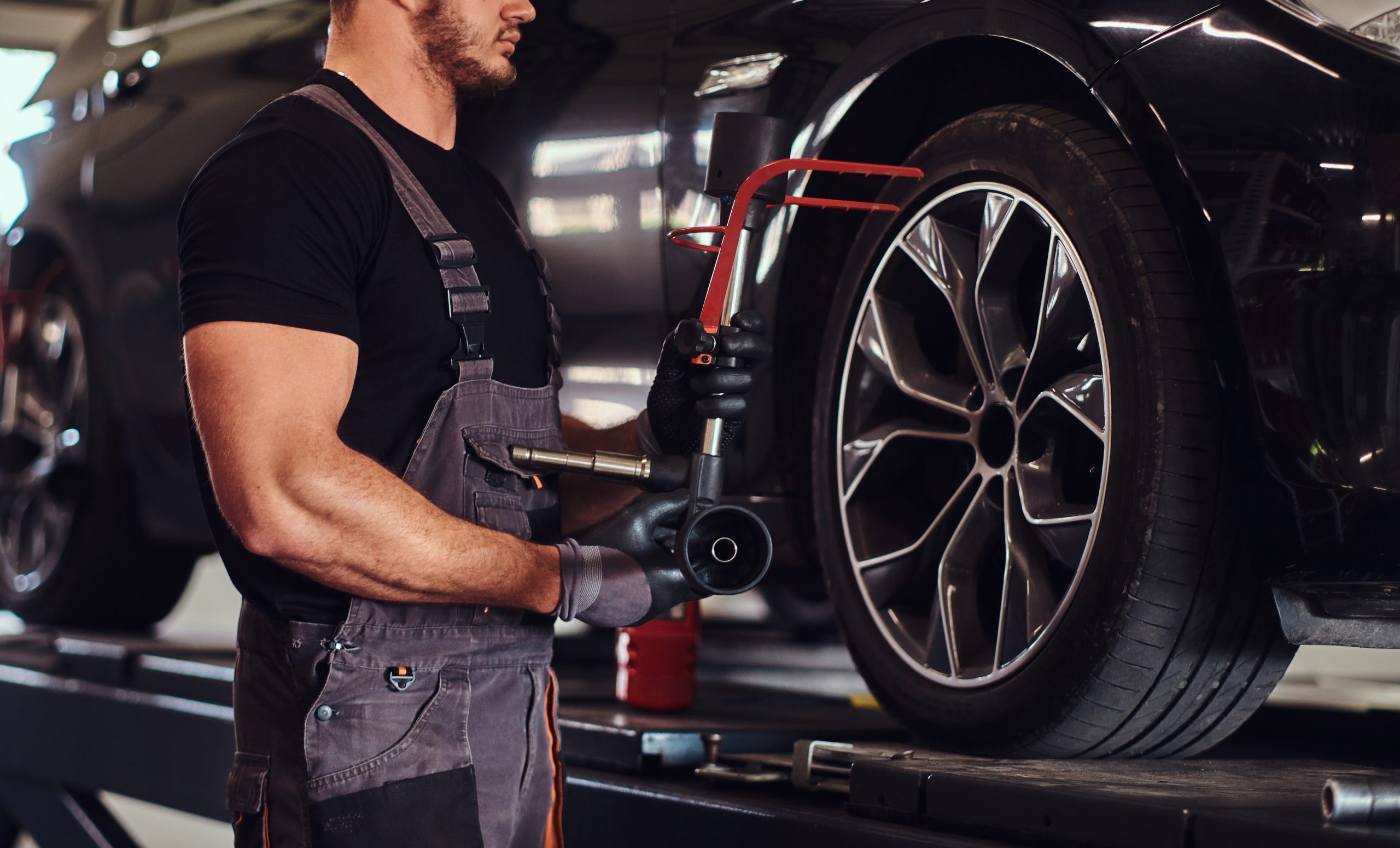 Retail tire services performed by a professional mechanic using specialized tools at TruFix Auto Repair in Nampa ID